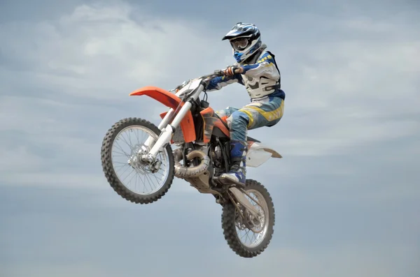 MX эффектно управляет мотоциклом в полете — стоковое фото