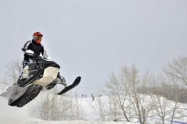 On the snowmobile rider flies sideways clipart