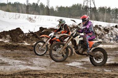 Two participants motocross compete in lifting mountains clipart