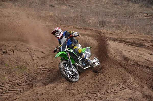 MX motorcycle with rider shoots out of a turn — Stock Photo, Image