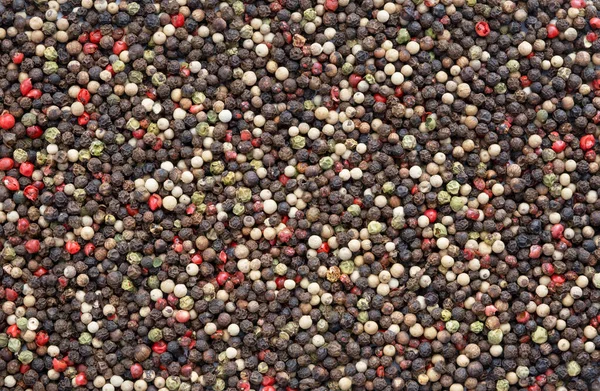 Mixed peppercorns background. Different colored peppercorns,  top view, full frame high resolution