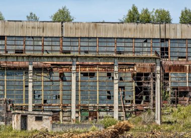 abandoned industrial building with broken windows, exterior view