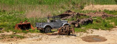 car cemetery with an engine and a car