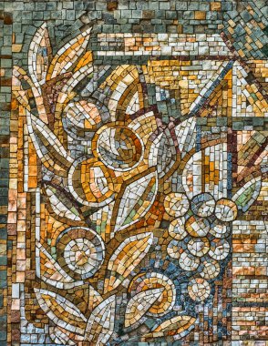 Colorful old stone mosaic on the wall bright tiles