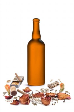matte orange wine bottle with petals of rose flowers, cigarettes, hot peppers, matches and Bronze ornamental keys on white backgroun