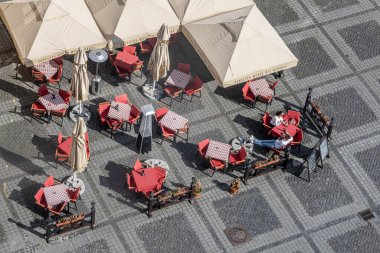Sibiu City, Romania - 15 April  2022. Outdoor terrace with tables and chairs, aerial top view People sitting and eating together near Sibiu old city center