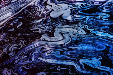 Rainbow colors created by diesel fuel floating on the water