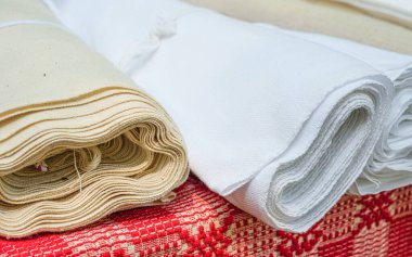 Romanian traditional material fabric rolls on table