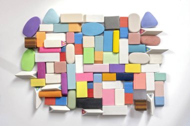 various shapes and colors of erasers arranged