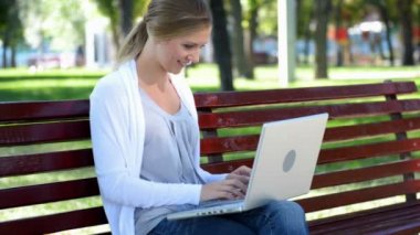 Young smiley woman typing on keyboard