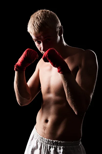 Boxer posing over black background — Stock Photo, Image