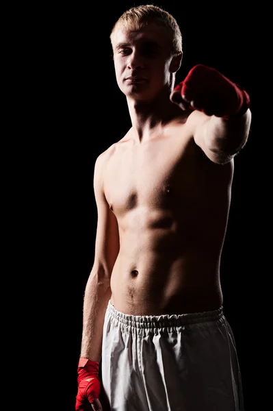 Fighter posing against black background — Stock Photo, Image