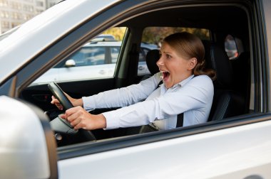 frightened woman sitting in the car