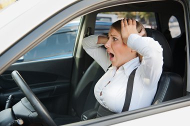 frightened woman sitting in the car