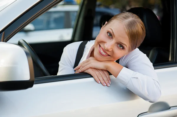 Donna d'affari seduta in macchina e sorridente — Foto Stock