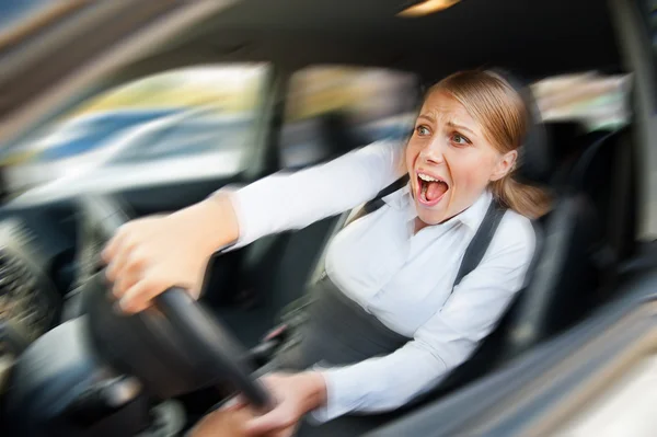 Female driving the car and screaming — Stock Photo, Image