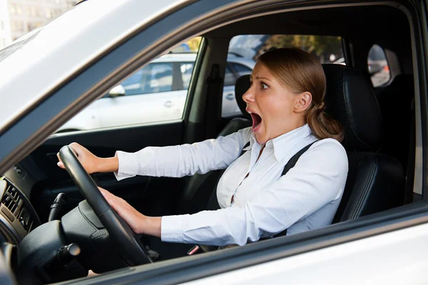 Woman driving the car and honking — Stockfoto