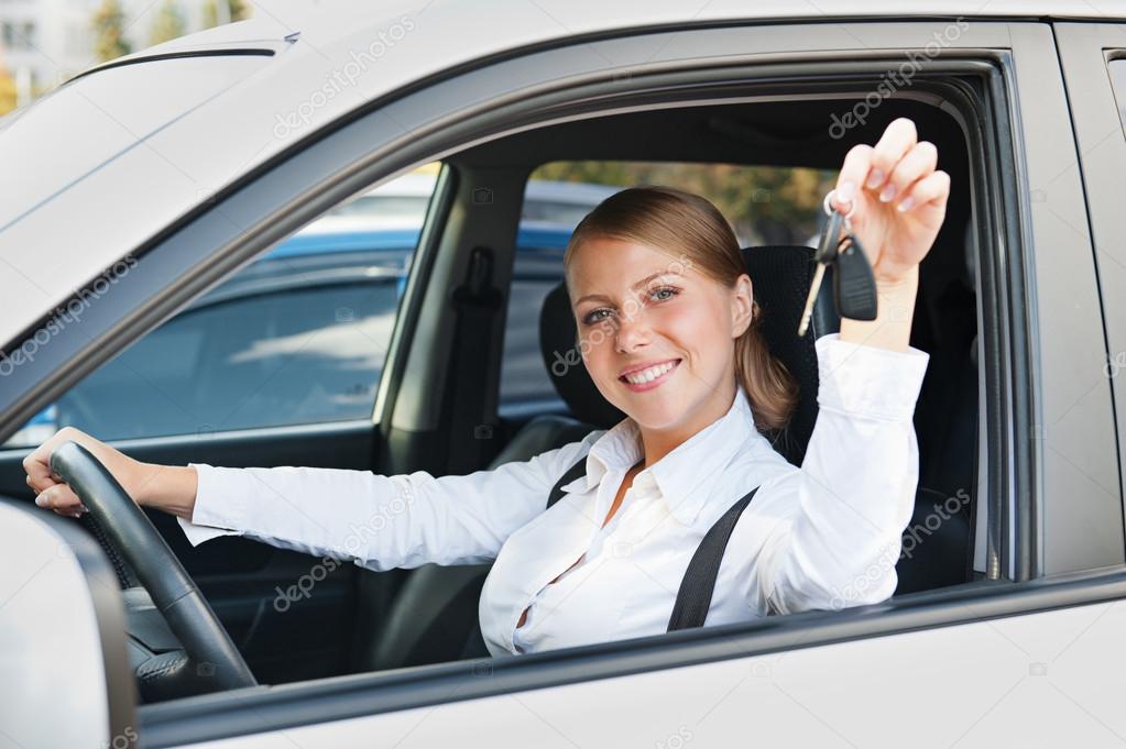 young woman sitting in car