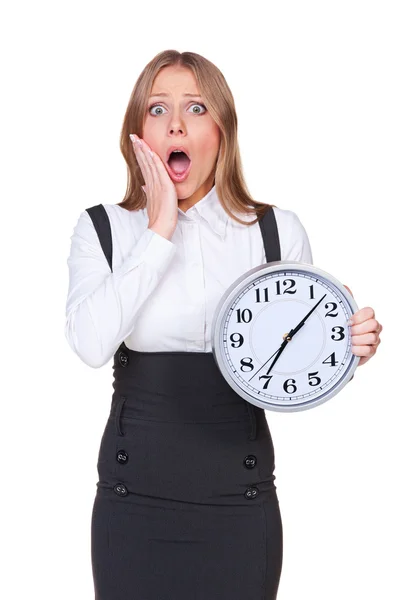 Shocked young woman holding the clock — Stock Photo, Image