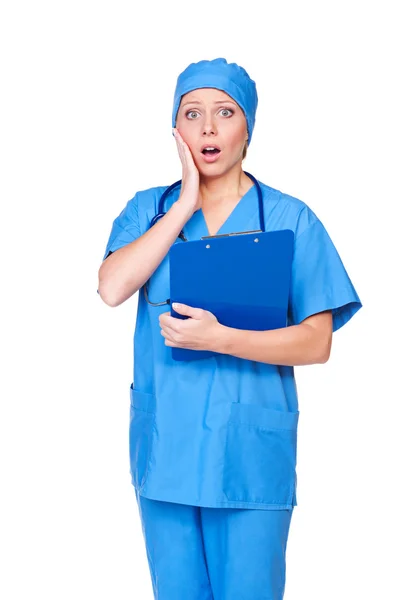 Geschokt vrouw in blauwe uniform — Stockfoto