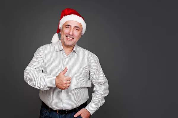 Senior man in santa hat standing — Stock Photo, Image