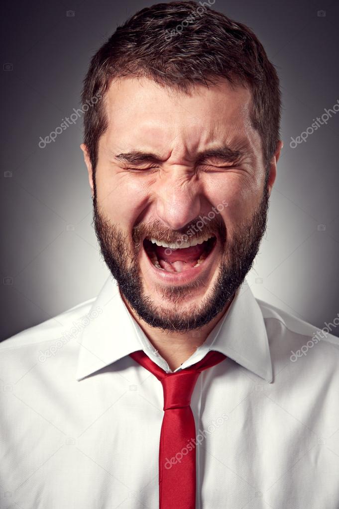 screaming man over grey background