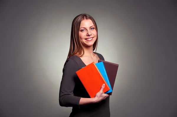 Pretty young woman holding the books Stock Picture