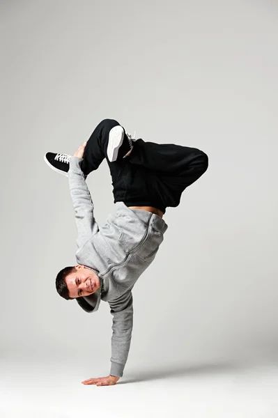 Hip-hop dancer over grey background — Stock Photo, Image