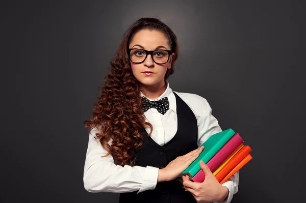Young teacher in glasses with pile of books — Stock Photo, Image