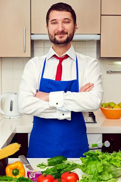 Man in blue apron with folded hands — Stock Photo, Image