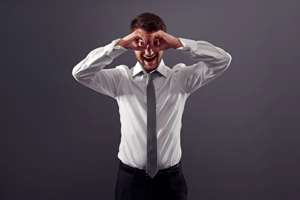 Man looking through imaginary binocular — Stock Photo, Image