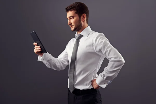 Serious man looking at tablet pc — Stock Photo, Image