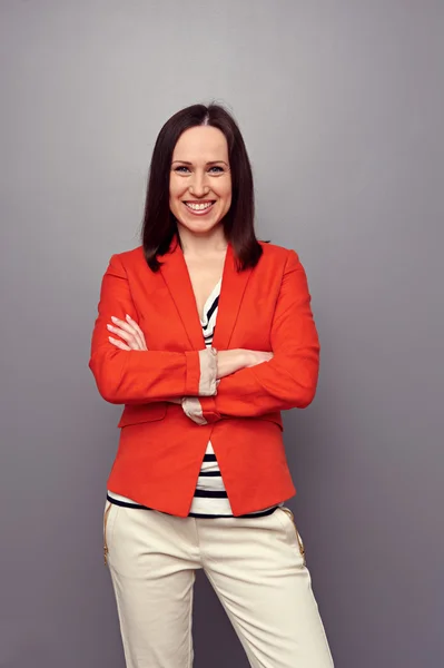 Cheerful young woman in red jacket — Stock Photo, Image