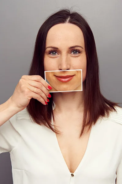 Woman hiding behind the picture — Stock Photo, Image