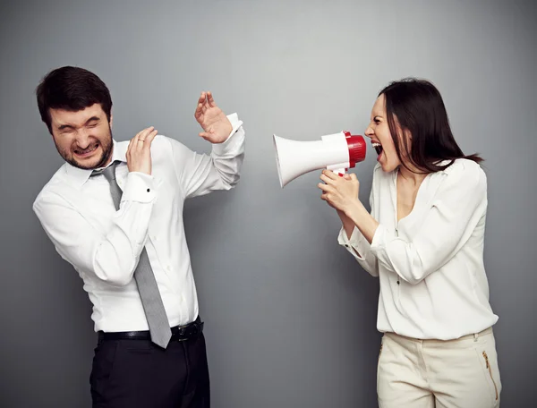 Woman screaming in megaphone at the man — Stock Photo, Image