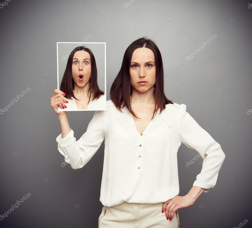 amazed young woman hiding her emotions