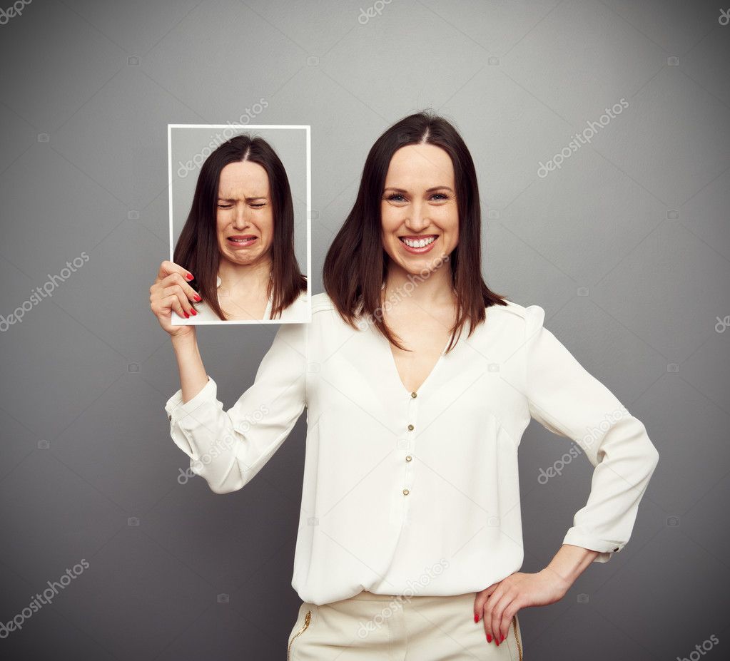 happy woman holding her sad picture