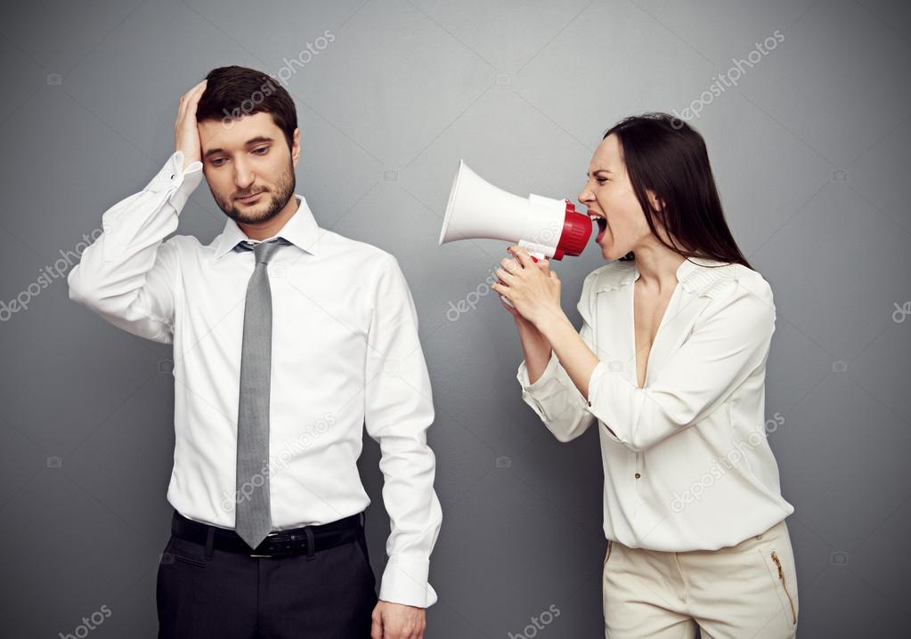 woman shouting in megaphone at the tired man