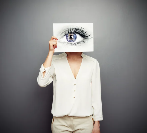 Mujer cubriendo imagen con ojo grande — Foto de Stock