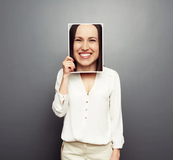 Vrouw die betrekking hebben op afbeelding met grote gelukkig gezicht — Stockfoto
