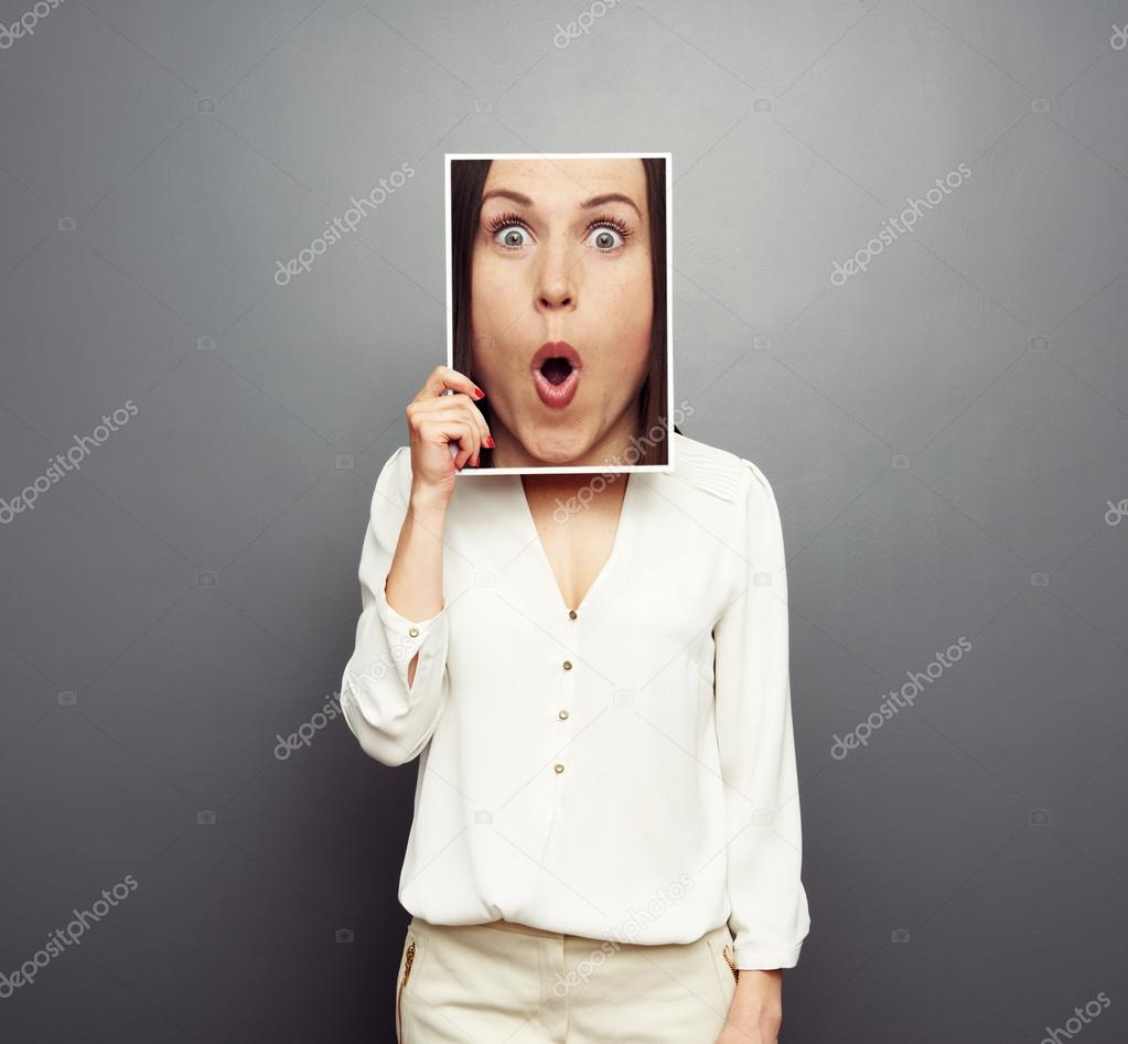 woman covering image with big amazed face