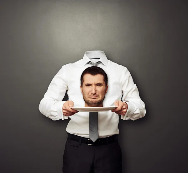 Headless man holding crying head on white plate — Stock Photo, Image