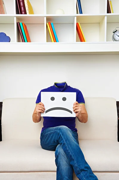 Faceless man sitting on sofa — Stock Photo, Image