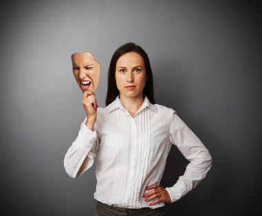 quiet woman holding aggressive mask clipart