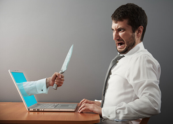 man looking at hand with knife