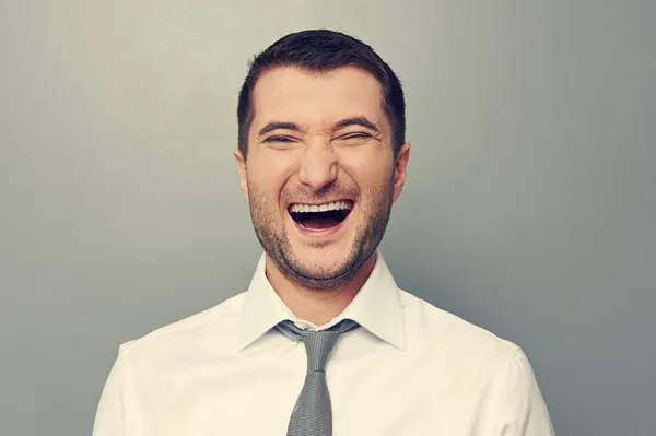 Joyful man over grey background — Stock Photo, Image