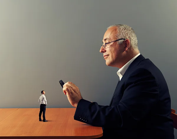 Businessman looking with magnifying glass — Stock Photo, Image