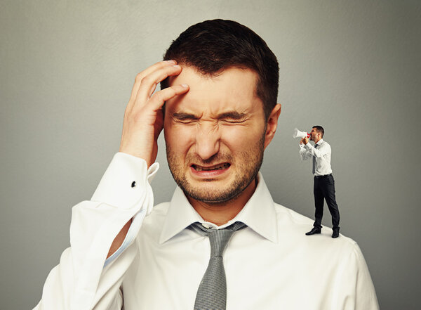 small man screaming at big man