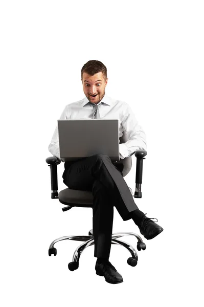 Smiley amazed businessman looking at laptop — Stock Photo, Image