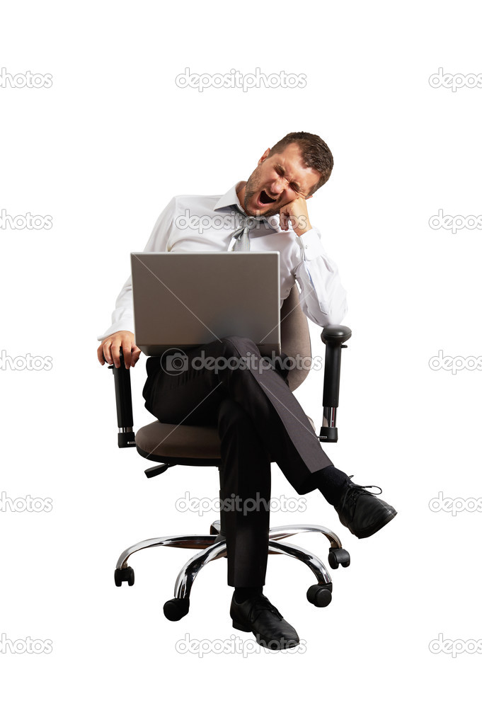 man sitting on office chair and yawning